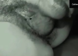 Woman with dark hair is having oral sex with a puppy